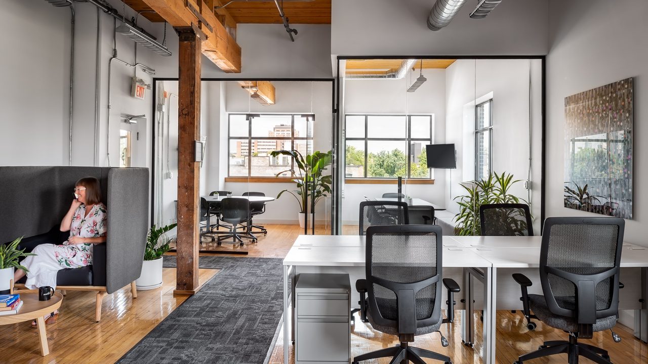 Open concept office with meeting rooms and windows