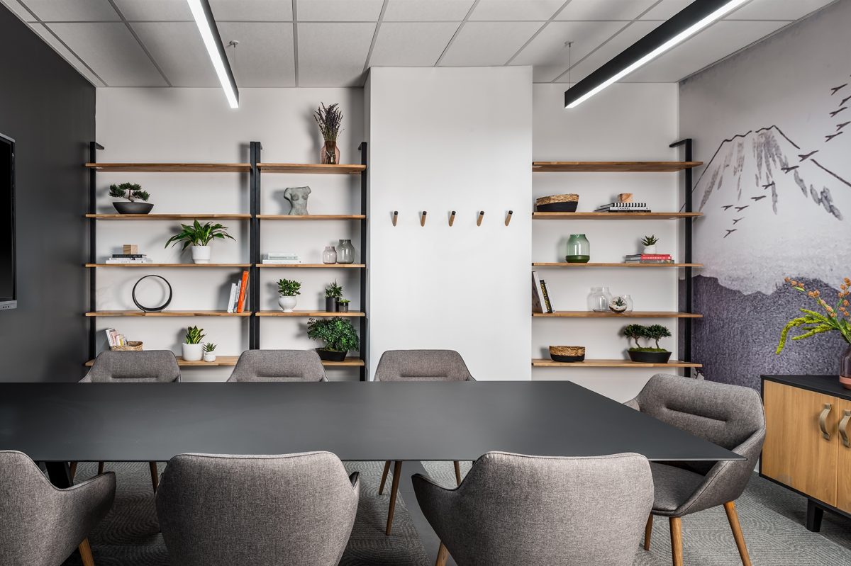 Small boardroom with grey chairs and shelves