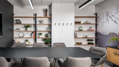 Small boardroom with grey chairs and shelves