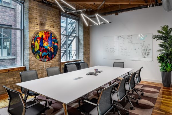 Meeting room with colourful artwork at Workplace One King East