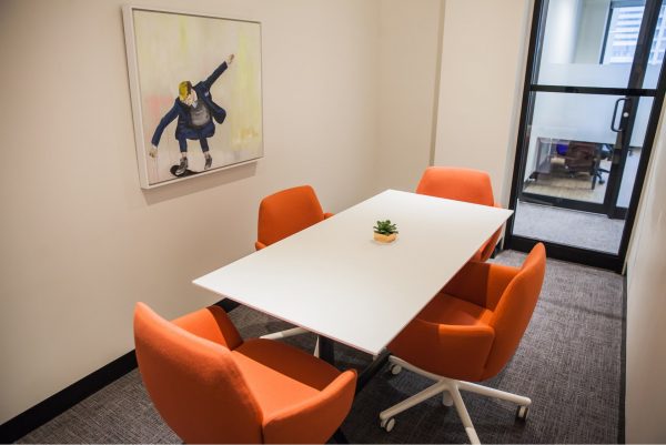 Small meeting room with orange chairs at Workplace One Bay-Bloor