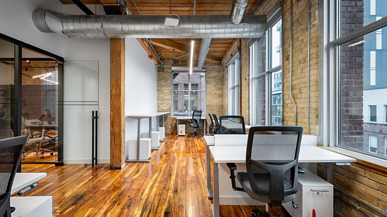Brick and beam private office at Workplace One King East