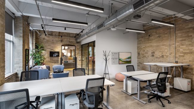 Team suite with brick walls at Workplace One King East